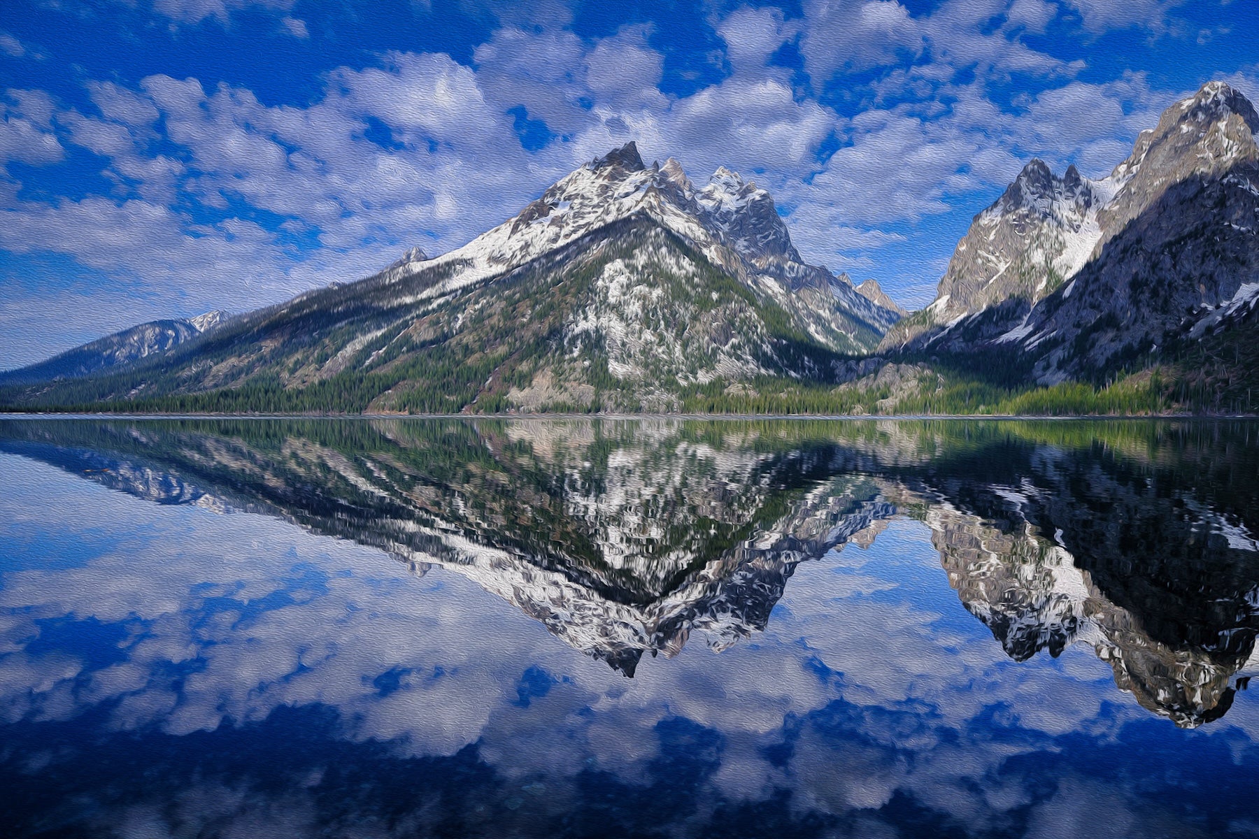 Jenny Lake in the Grand Tetons, Wyoming, with crystal clear water reflecting high mountain ranges under a bright sky.