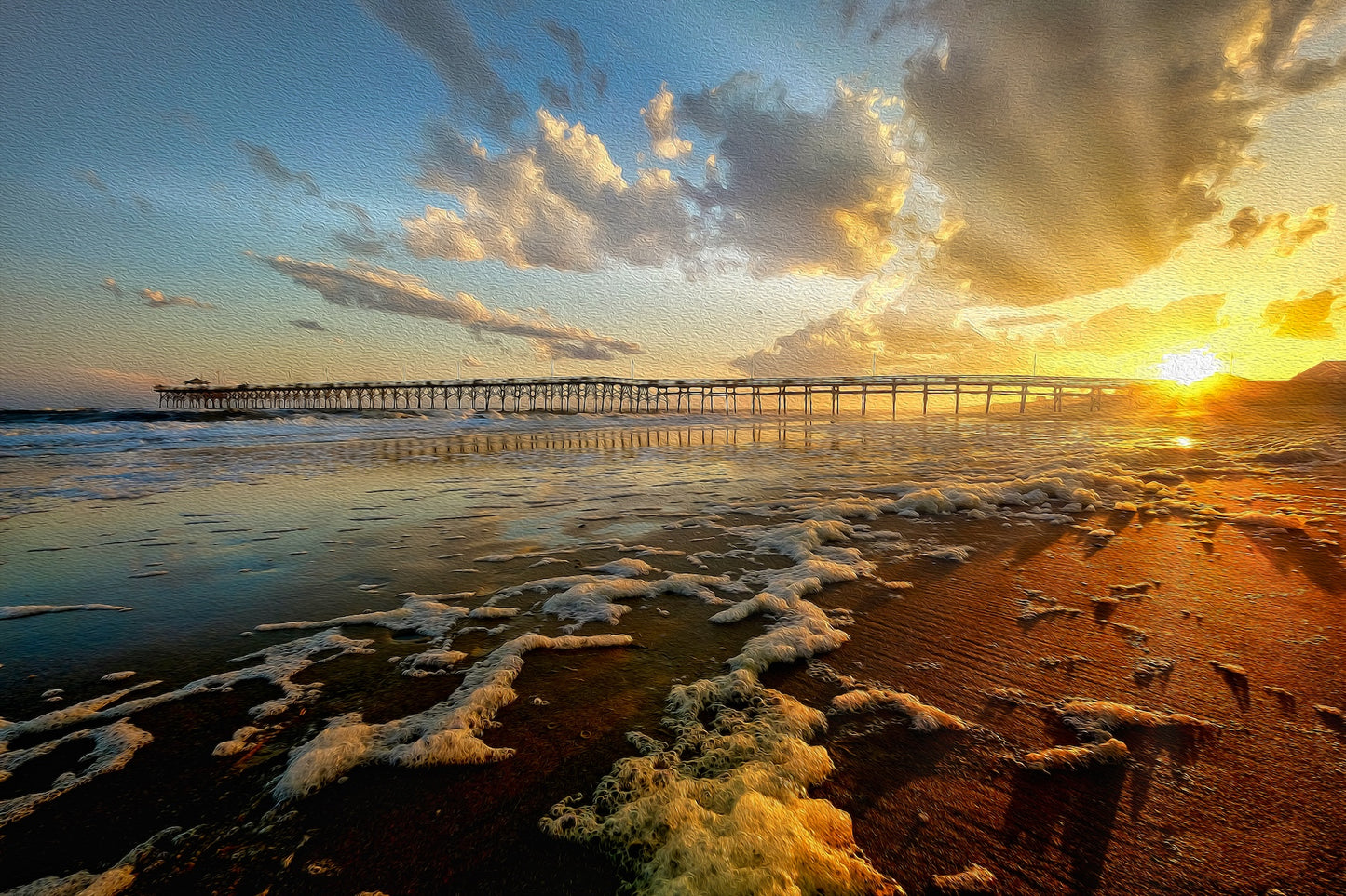 Colorful sunset over Oceancrest Pier in Oak Island, North Carolina, with vivid skies and the pier stretching toward the ocean.