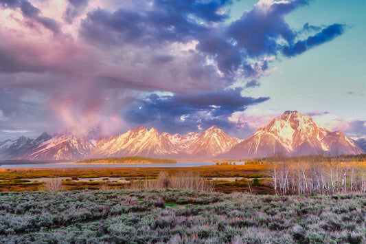 Landscape of Jackson Lake, Wyoming, with Grand Teton mountains in the background and a massive atomic-shaped cloud illuminated by sunrise.