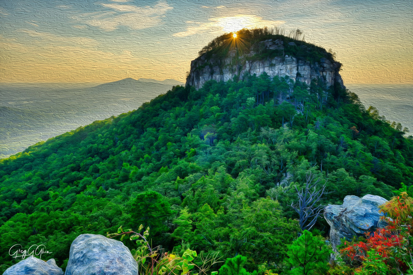 Sunrise over Pilot Mountain, North Carolina—distinctive peak towers above the Piedmont plateau, bathed in warm morning light.